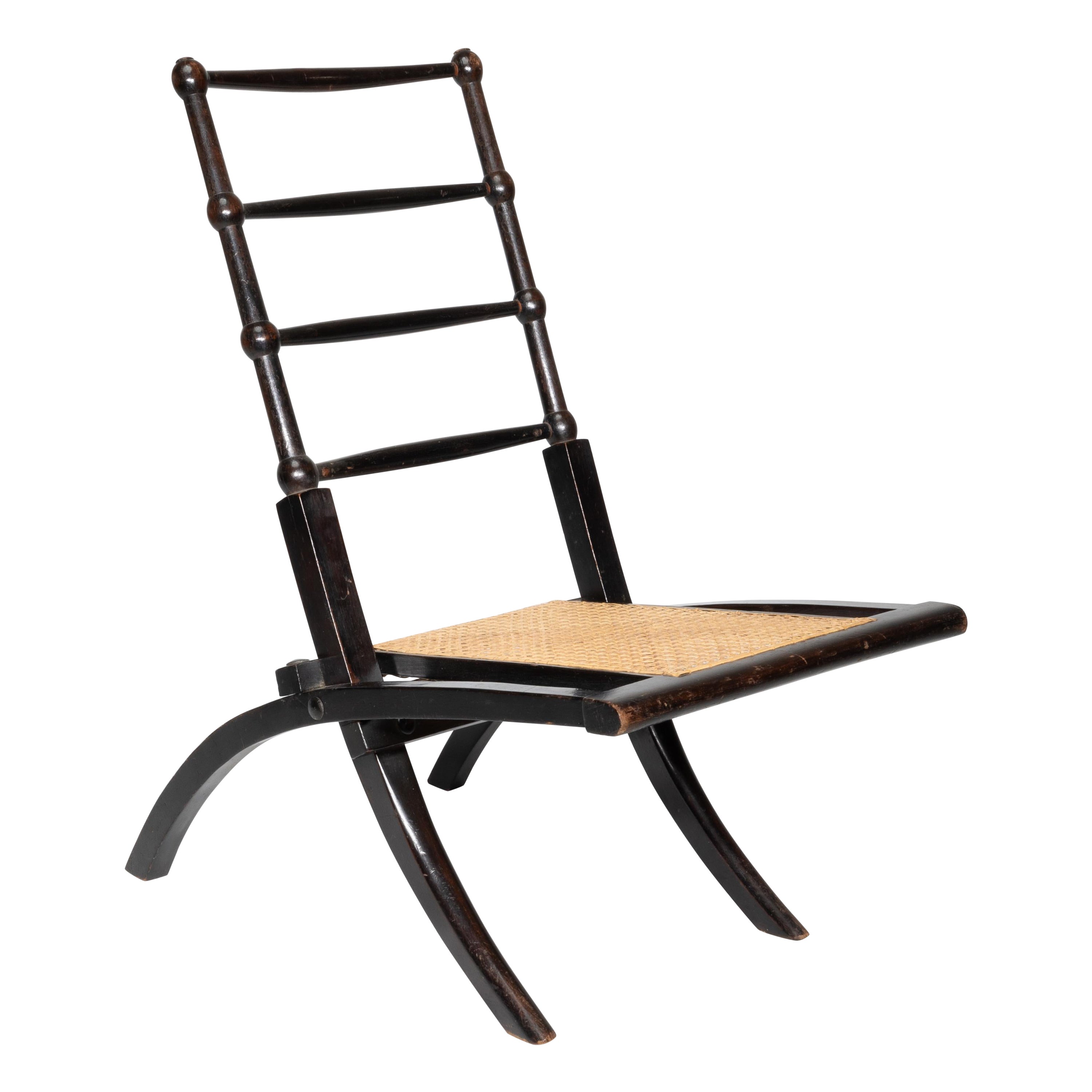 EW Godwin Style of. Aesthetic Movement ebonized folding chair with new cane seat