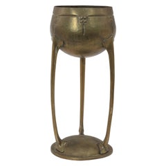 Antique WMF. A hand beaten brass chalice, the bowl raised on three organic supports.