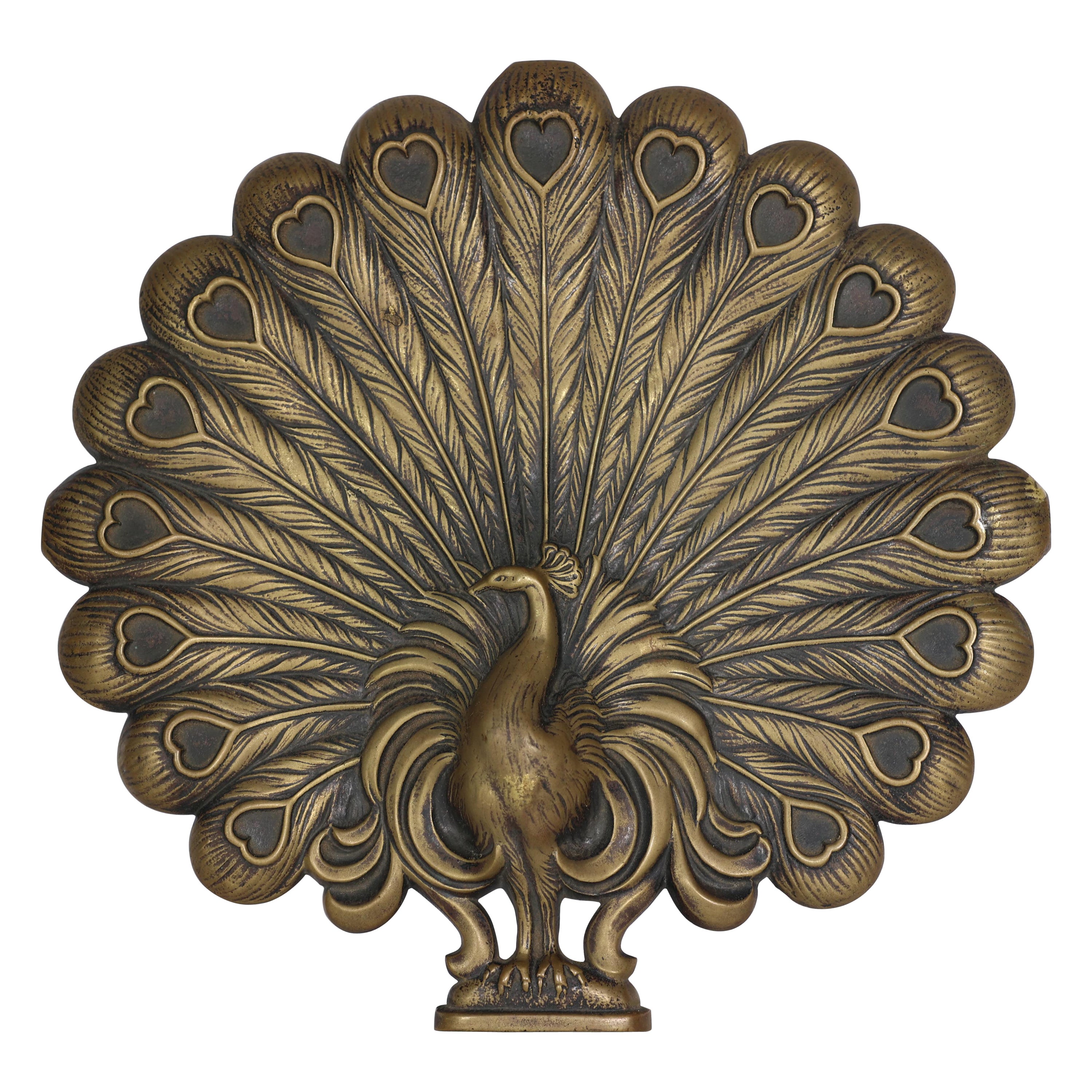 An Aesthetic Movement heavy cast brass peacock trivet with fine detailing