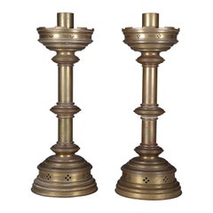 Antique Jones and Willis. A pair of Gothic Revival heavy brass castellated candlesticks 
