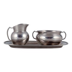 Just Andersen, creamer and sugar bowl on tray in pewter. 940s.