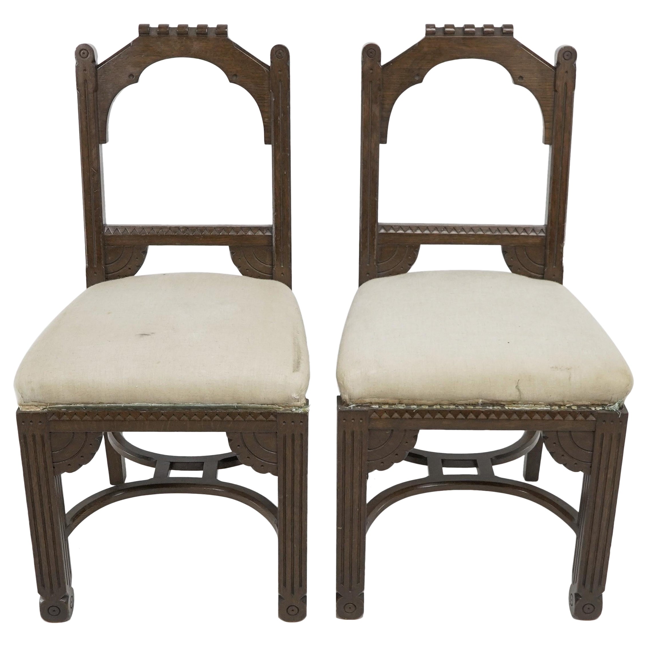 R Boyd. in the style of Dr C Dresser. A pair of Aesthetic Movement oak side chairs with 1/4 moon details and double hoop stretchers. Furniture by R Boyd was illustrated in the Furniture Gazette when Dr C Dresser was the editor between 1880 and 1881.