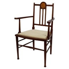 Antique Liberty and Co in the style of G M Ellwood. An Arts and Crafts Walnut armchair