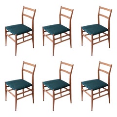 Used Gio Ponti set of 6 chairs in wood with fabric covering.