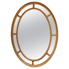 Espejo de pared oval victoriano de madera dorada y gesso