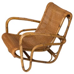 Vintage Rattan & Wicker Armchair in the style of Joseph André Motte - France 1960's