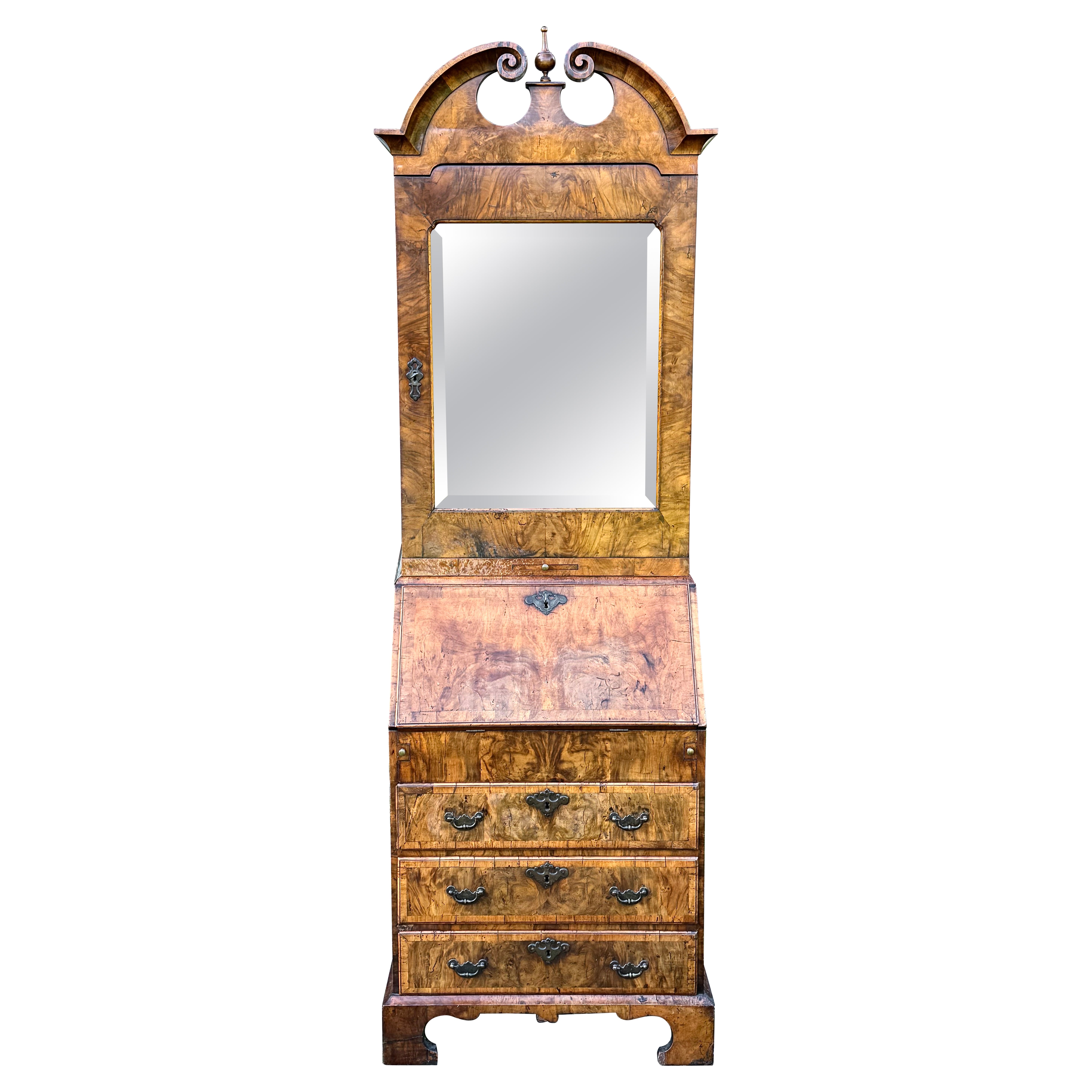 A rare, small, English early-18th century walnut bureau bookcase/ cabinet with a moulded swan-neck pediment. Circa 1727-1730. On the cusp of George I- into George II-period.

The bevelled-mirror plate has a candle slide below.

The lower writing
