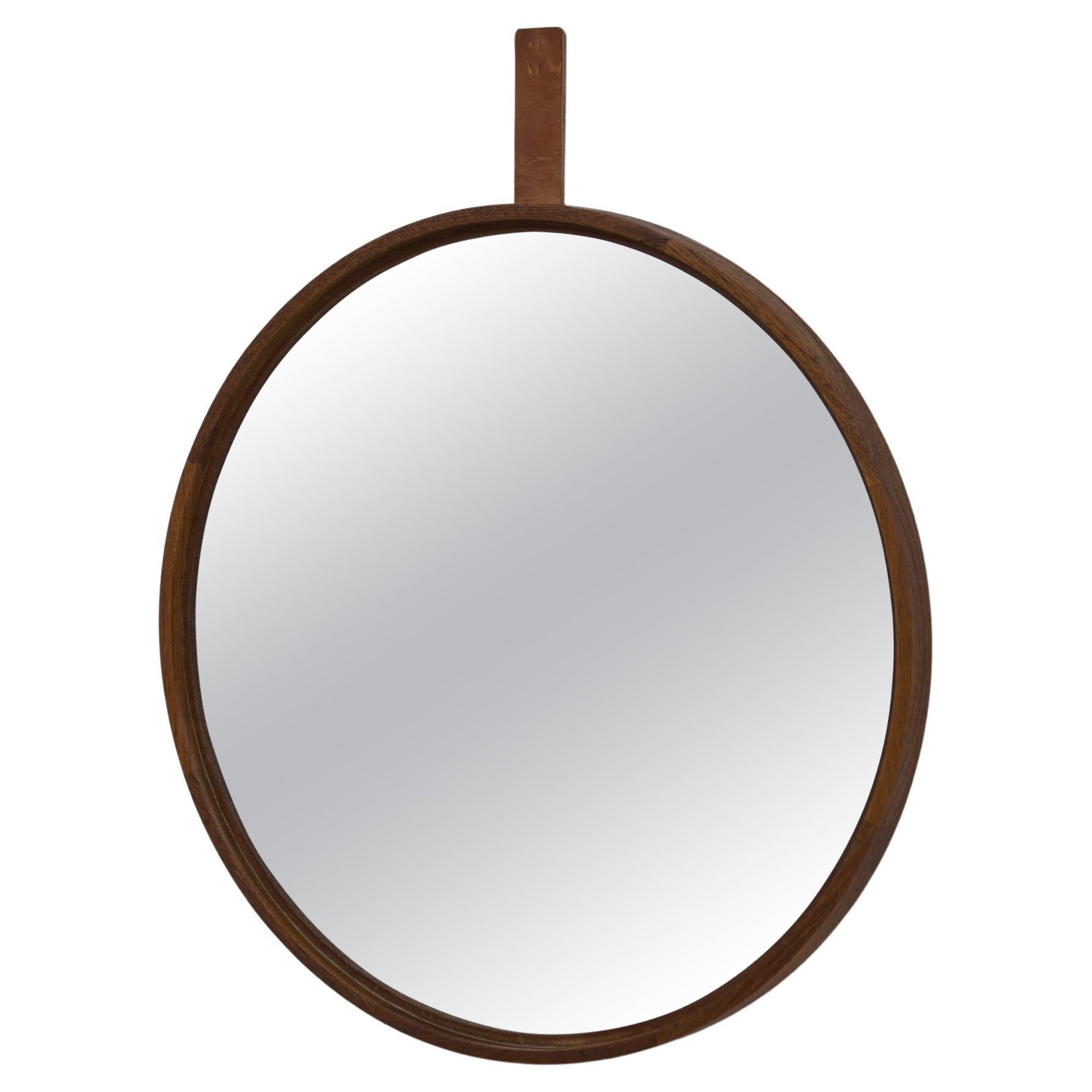 Round teak and leather wall mirror by Uno & Östen Kristiansson. For Sale