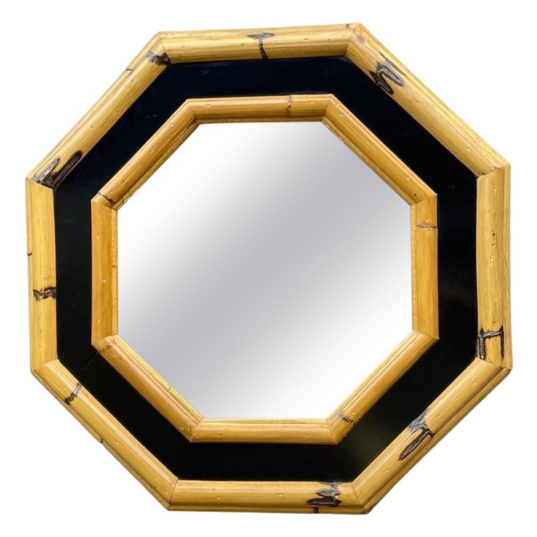 A 1970s Italian octagonal bamboo mirror with black laminated centre For Sale