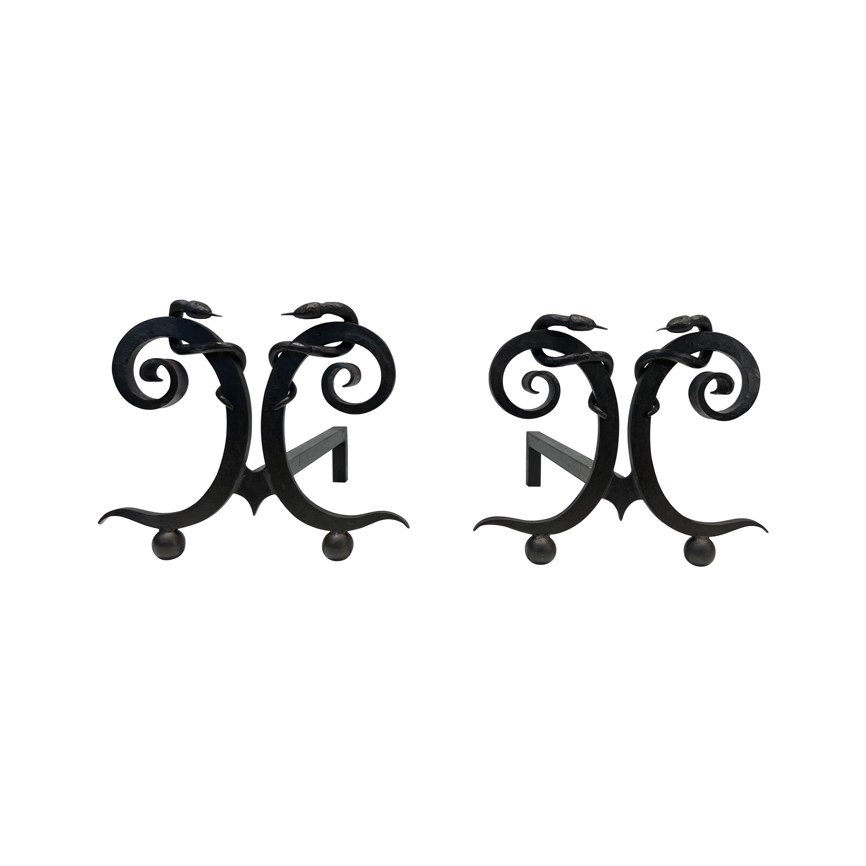 Pair of wrought iron andirons with Snakes in the style of Edgar Brandt For Sale