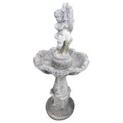 Vintage stone garden fountain with carved putto, Italy