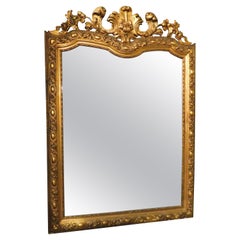 Gilt wooden wall consolle mirror with carved cymatium, Italy
