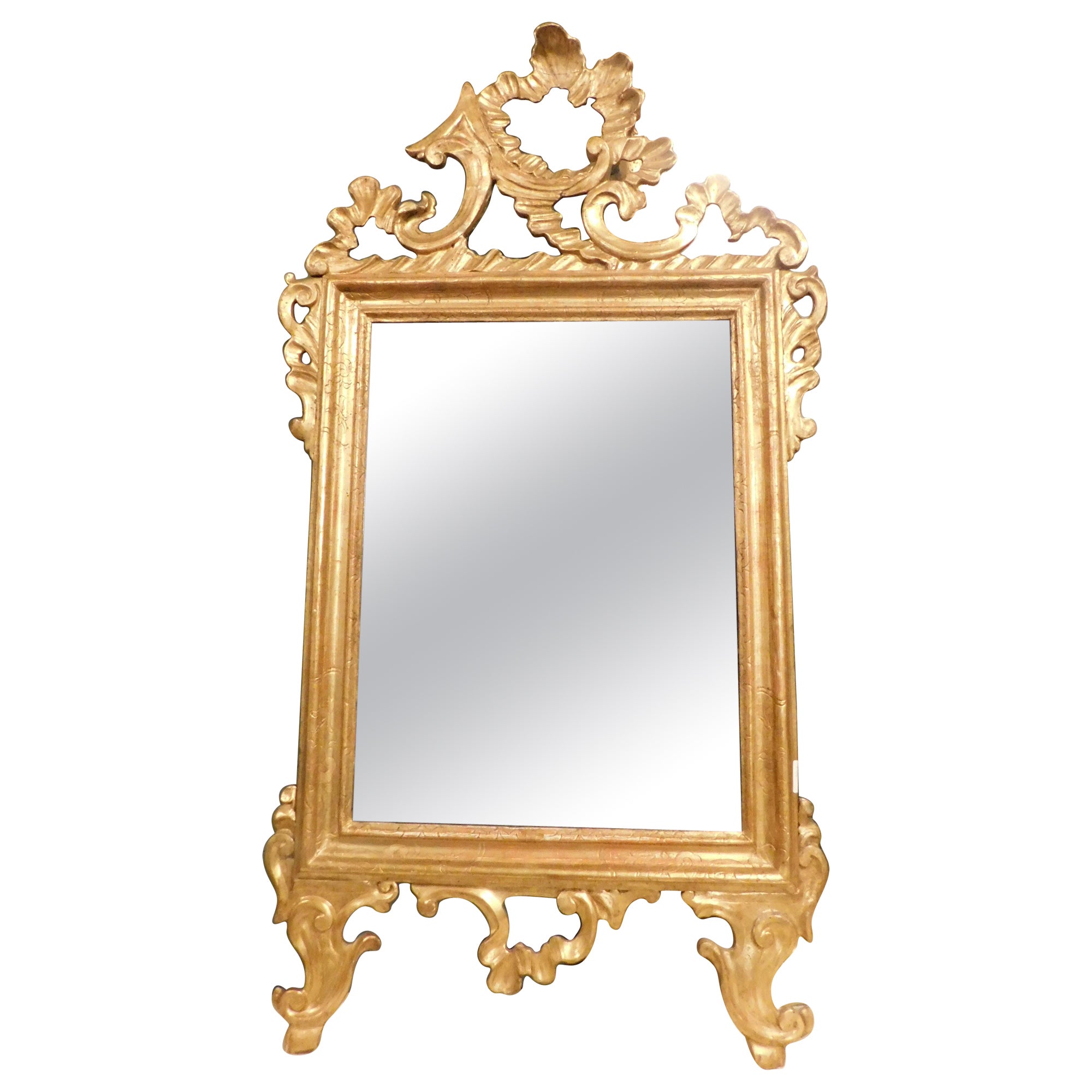 Ancient mirror in gilded and carved wood, France