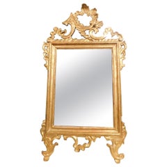 Miroir ancien en bois doré et sculpté, France