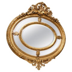 Old mirror in gilded and richly carved wood, France