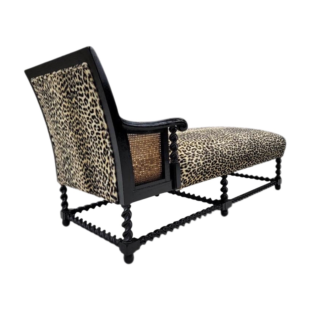 Antique English Ebony Oak Barley-Twist & Cane Chaise Lounge in a Plush Cheetah Print Poly-Fur Fabric 

Step back in time and immerse yourself in the timeless elegance of this early 1900's English rectangular caned chaise lounge raised on barley