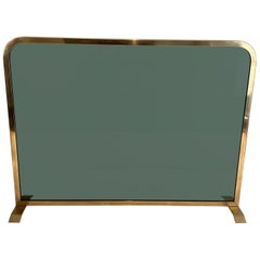 Retro Fireplace Screen Made of a Greenish Glass Panel Surrounded by a Brass Frame