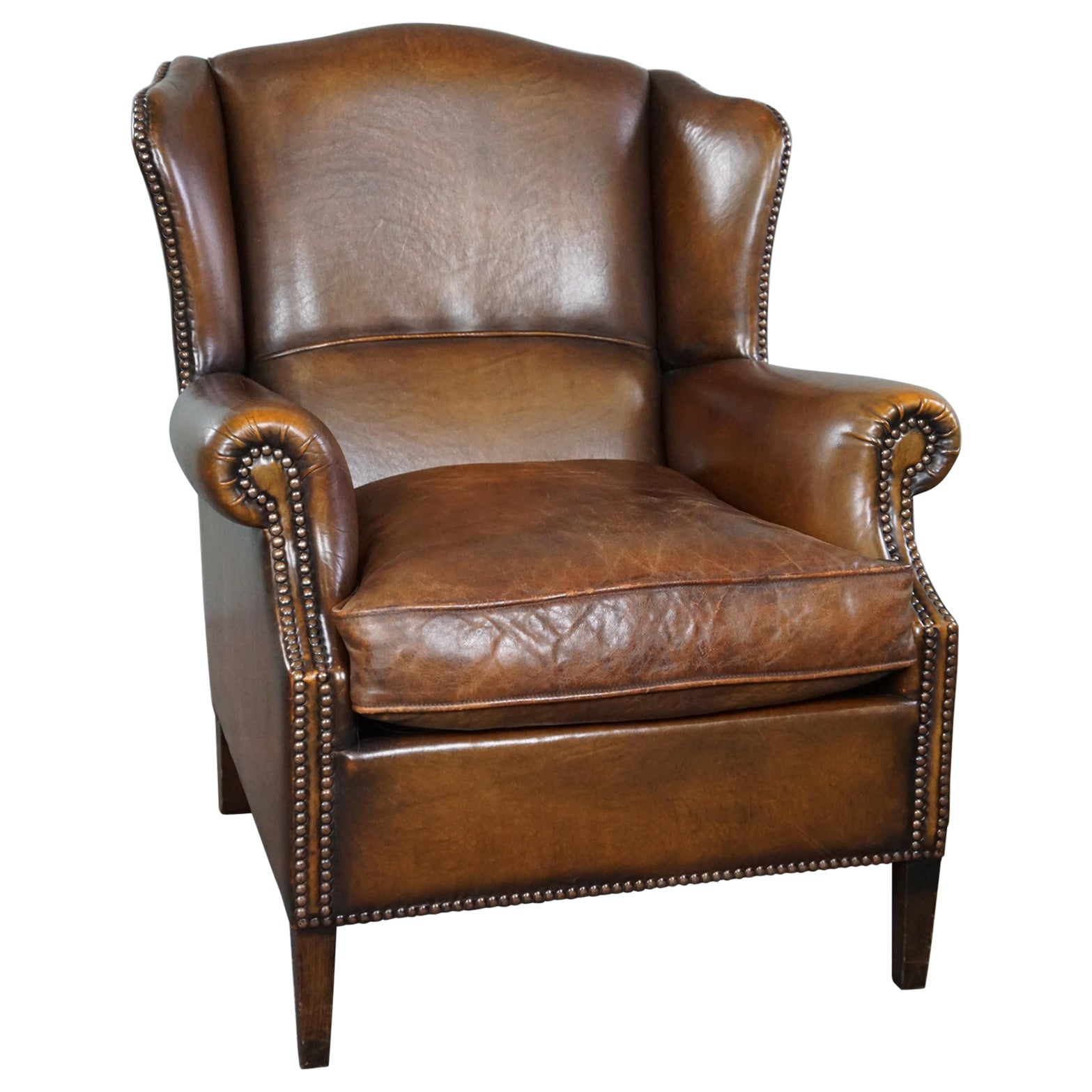 In good condition wingback chair made of sheepskin For Sale