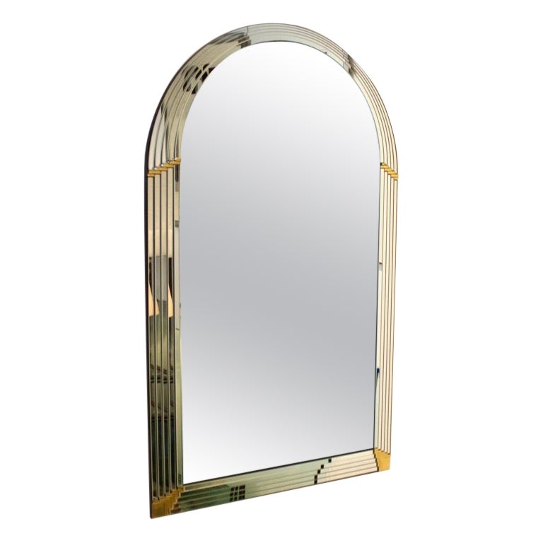 Sophisticated Mirror designed and manufactured by the Belgian company Deknudt.  The mirror is visually striking with beautiful layered mirrored panels with unique decorative Brass accents. The mirror adds a touch of elegance and refinement to any