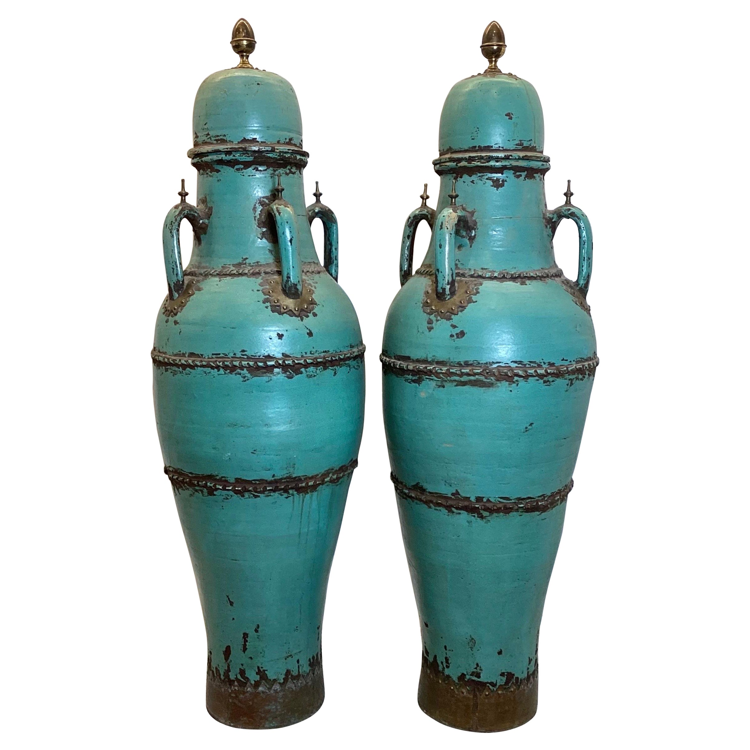 A Pair of Monumental Four Handled Tall Pottery Urns For Sale