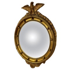Antique Federal-style convex guiltwood bulle-eye mirror