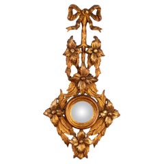 Miroir convexe rocococo en bois doré avec nœud et ruban