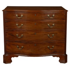 A mahogany four-drawer serpentine chest of drawers