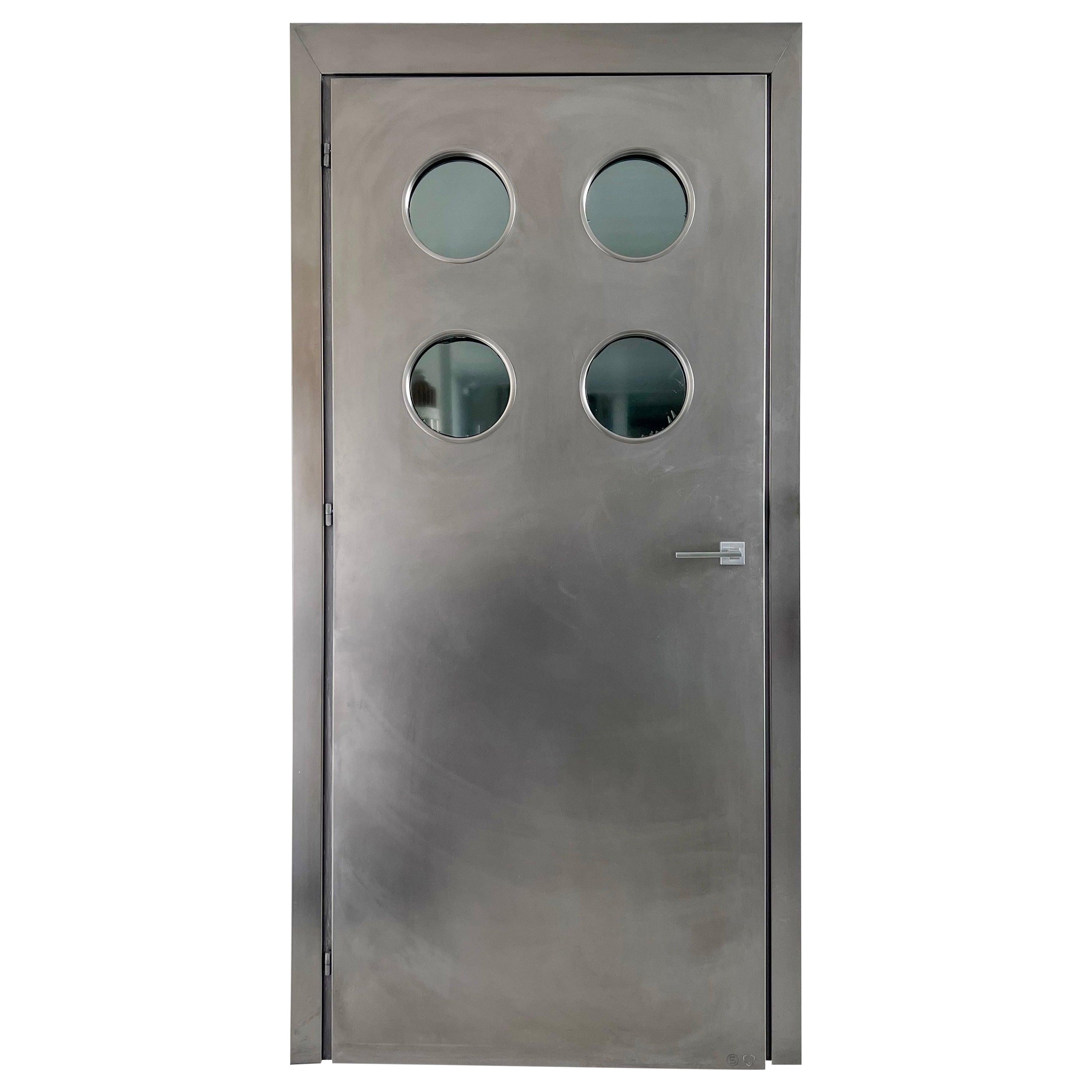 Contemporary custom made Spinzi stainless steel metal door with round portholes For Sale
