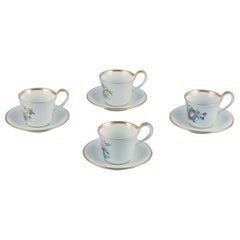 Bing & Grøndahl. Set of four antique coffee cups with high handles and saucers.