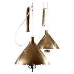 Paavo Tynell, pair of 1940's brass counterweight pendant lamps, Taito Oy