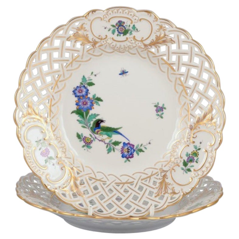 Meissen, Germany. Two open lace plates in porcelain, decorated with exotic bird For Sale