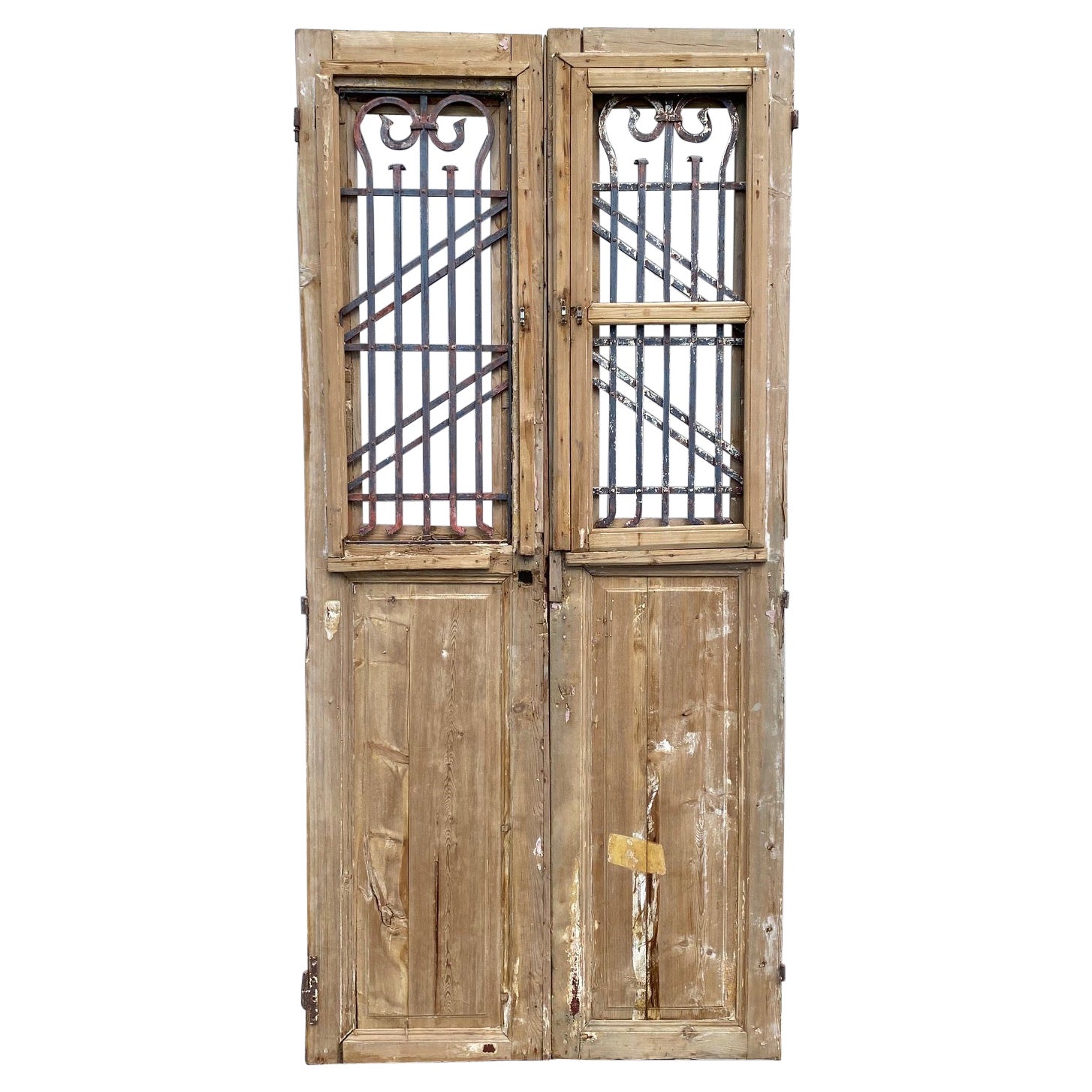 Pair of 19th Century French Paneled Doors with Intricate Wrought Iron Panels For Sale