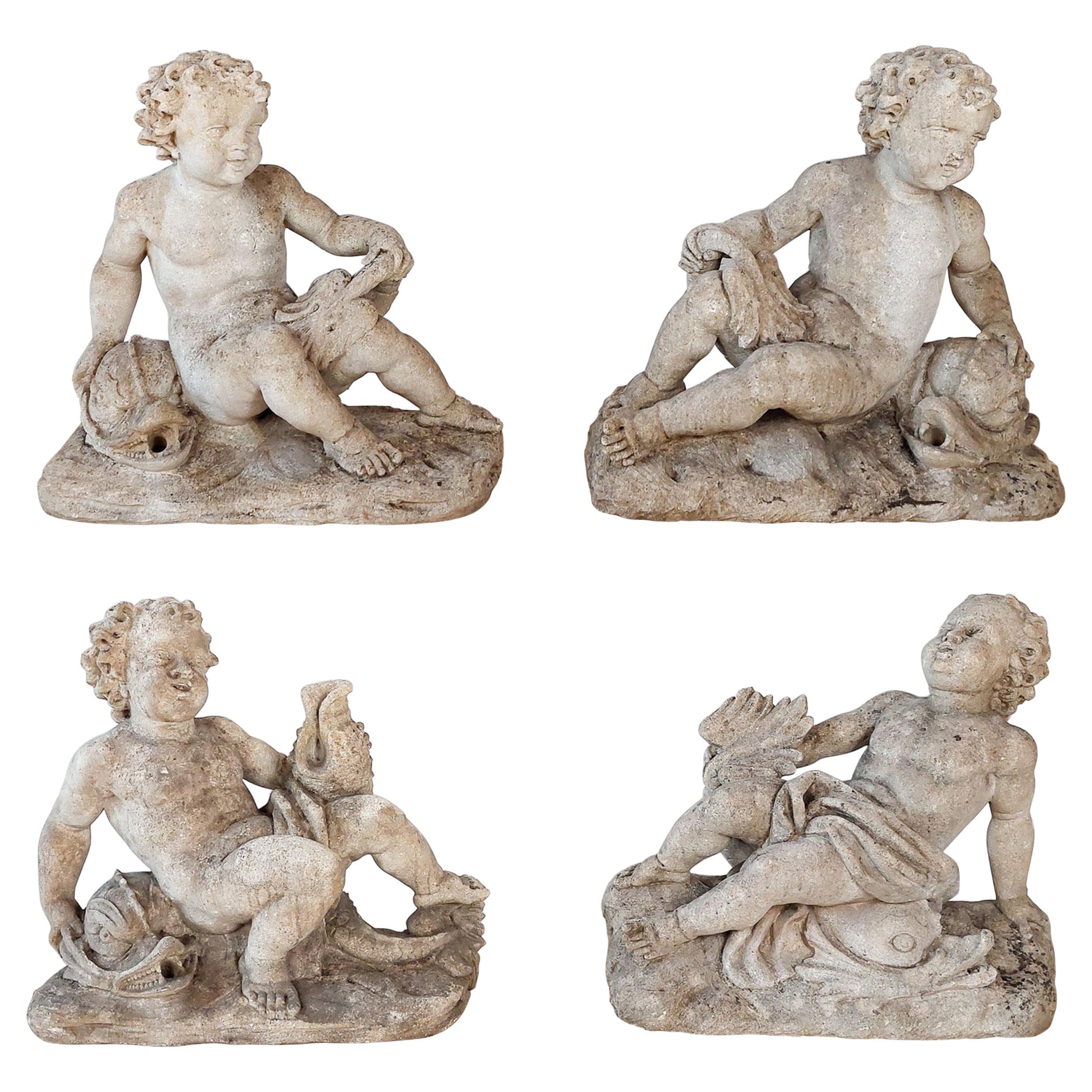 Set of 4 carved limestone fountain putti seated with dolphins For Sale