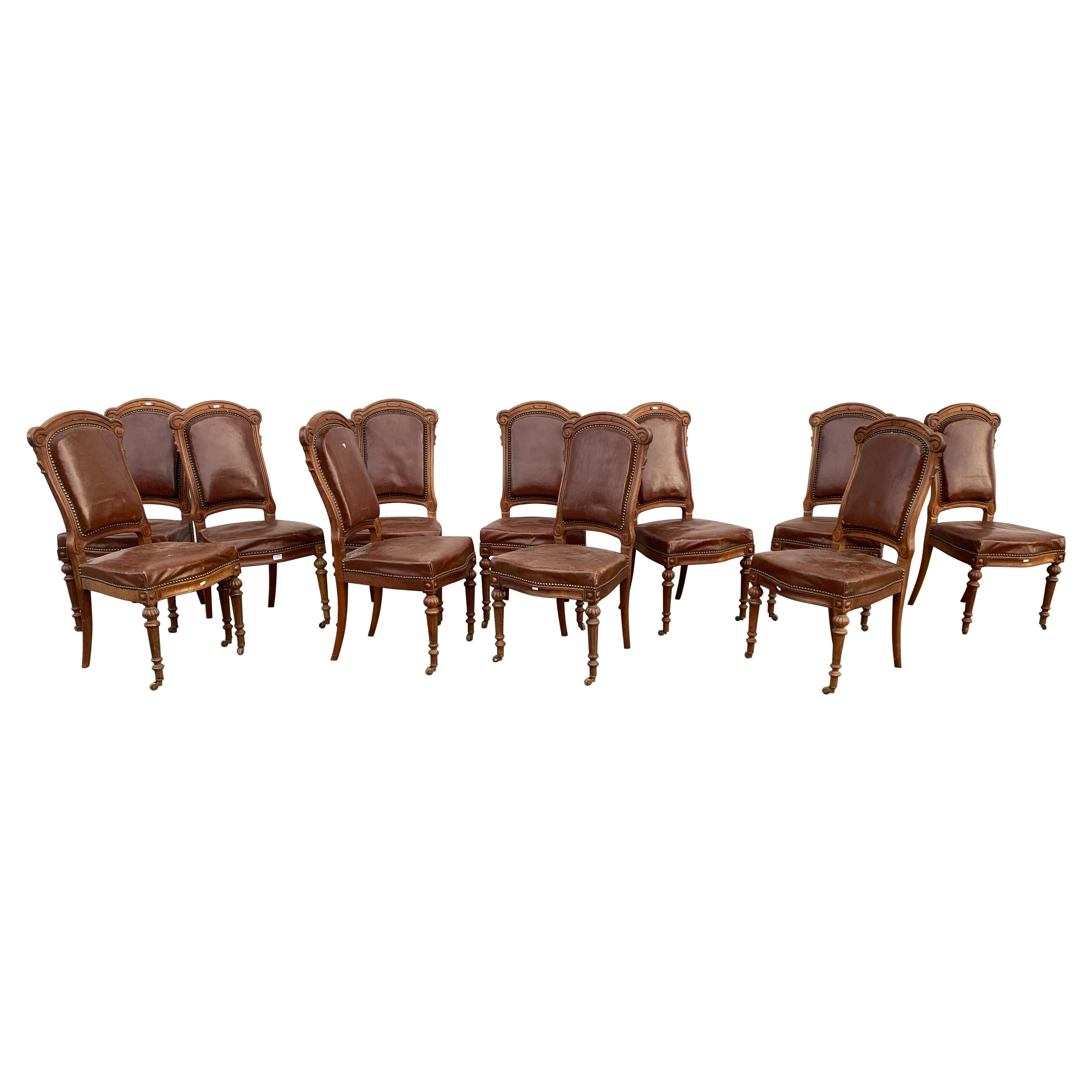 Rare suite of 12 Louis Philipe period chairs in oak and leather, 19th century 
