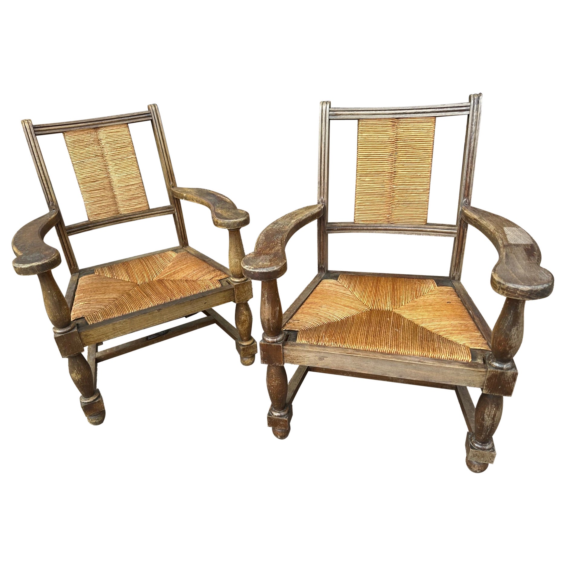 Pair of wood structure chairs with woven rush seat and back. Antique condition, wear is consistent with age, circa 1950s.