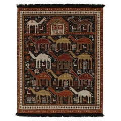 Rug & Kilim’s Tribal Style Rug in Black with Red, Gold-Brown Pictorial Patterns