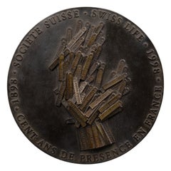 Arman (after) : "La main tendue", Patinated bronze medallion, 1998