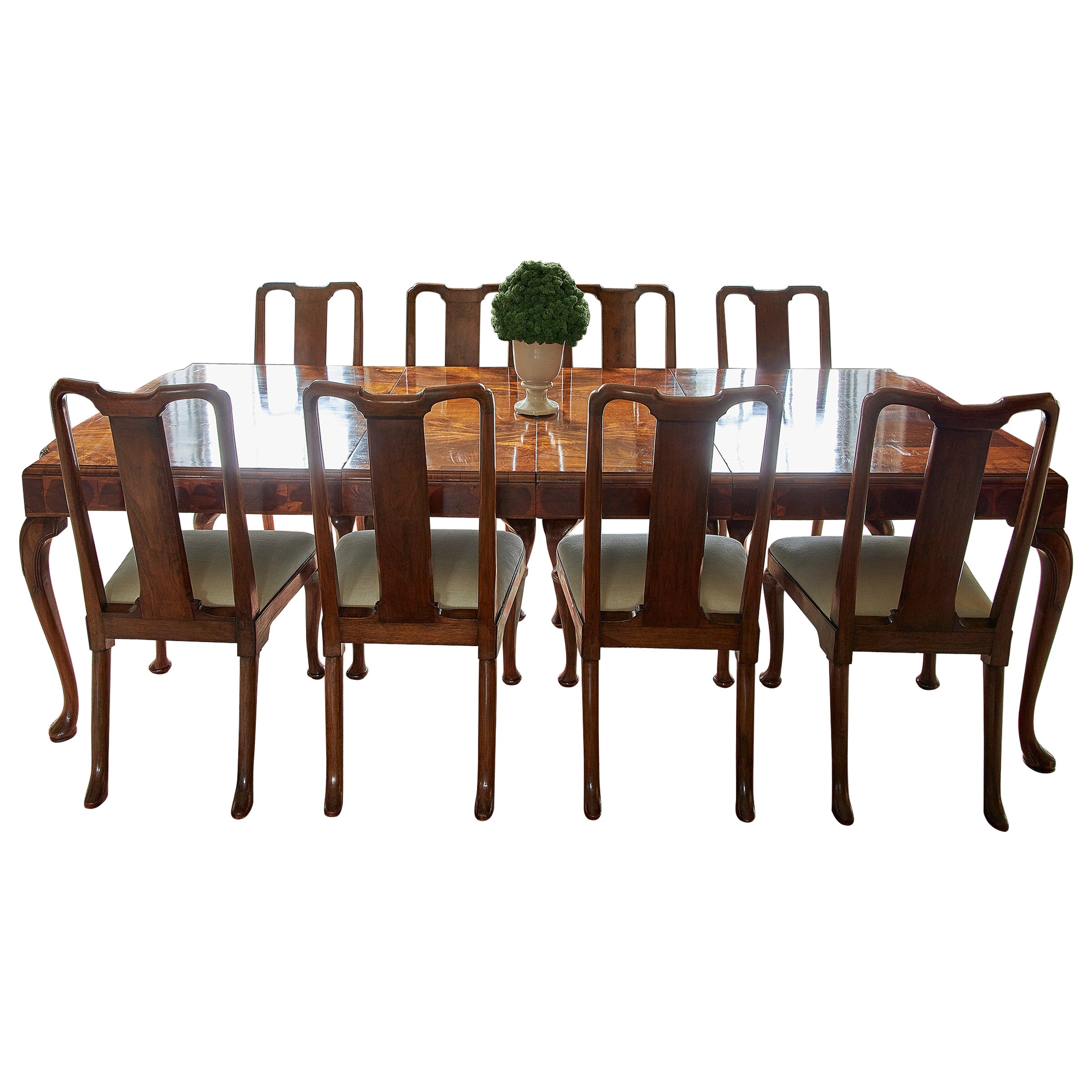 A George I style walnut veneer extending dining table and twelve dining chairs