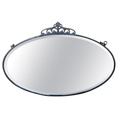 Oval antique Art Nouveau mirror with a thin brass frame and crown 