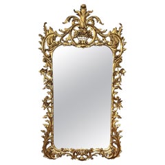A Well-Carved French Rococo Style Giltwood Wall Mirror with Exuberant Crest