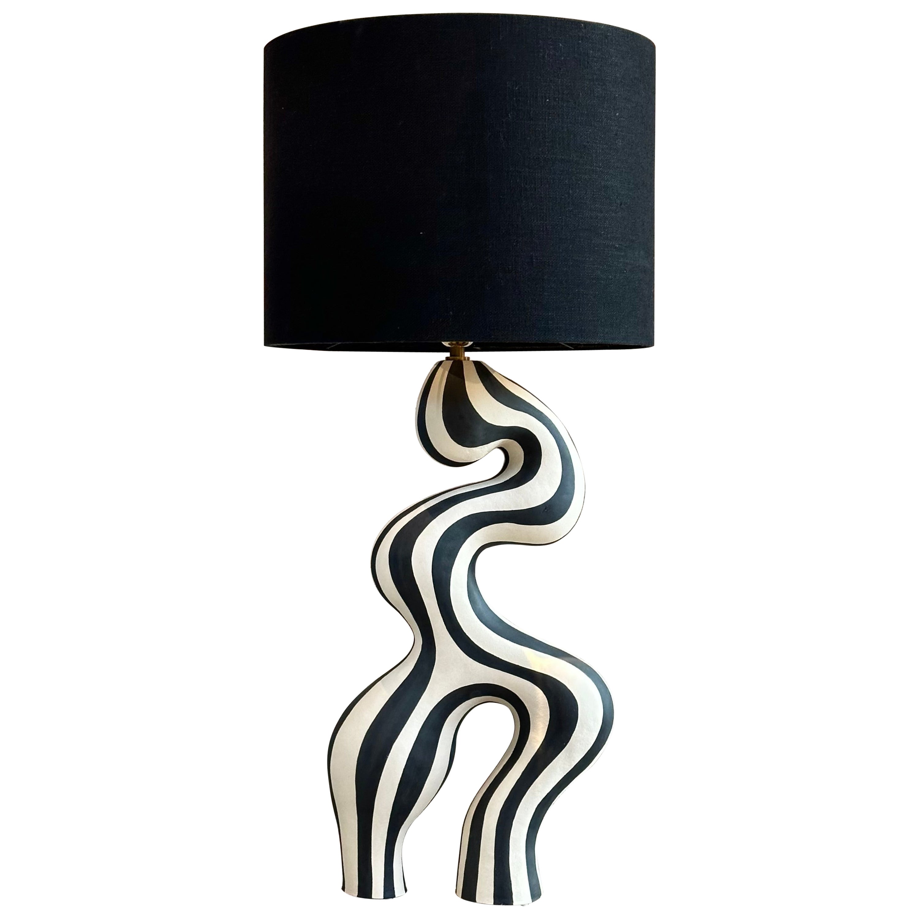 A statement piece designed and handcrafted by ceramic artist Johanne Birkeland who works under the artist name Jossolini. The lamp base is hand built in white stoneware clay, and hand decorated with black matte glaze. 

The Norwegian artist works