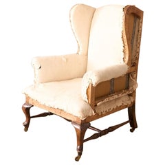 Retro Victorian stretchered wingback armchair by John Reid & Sons