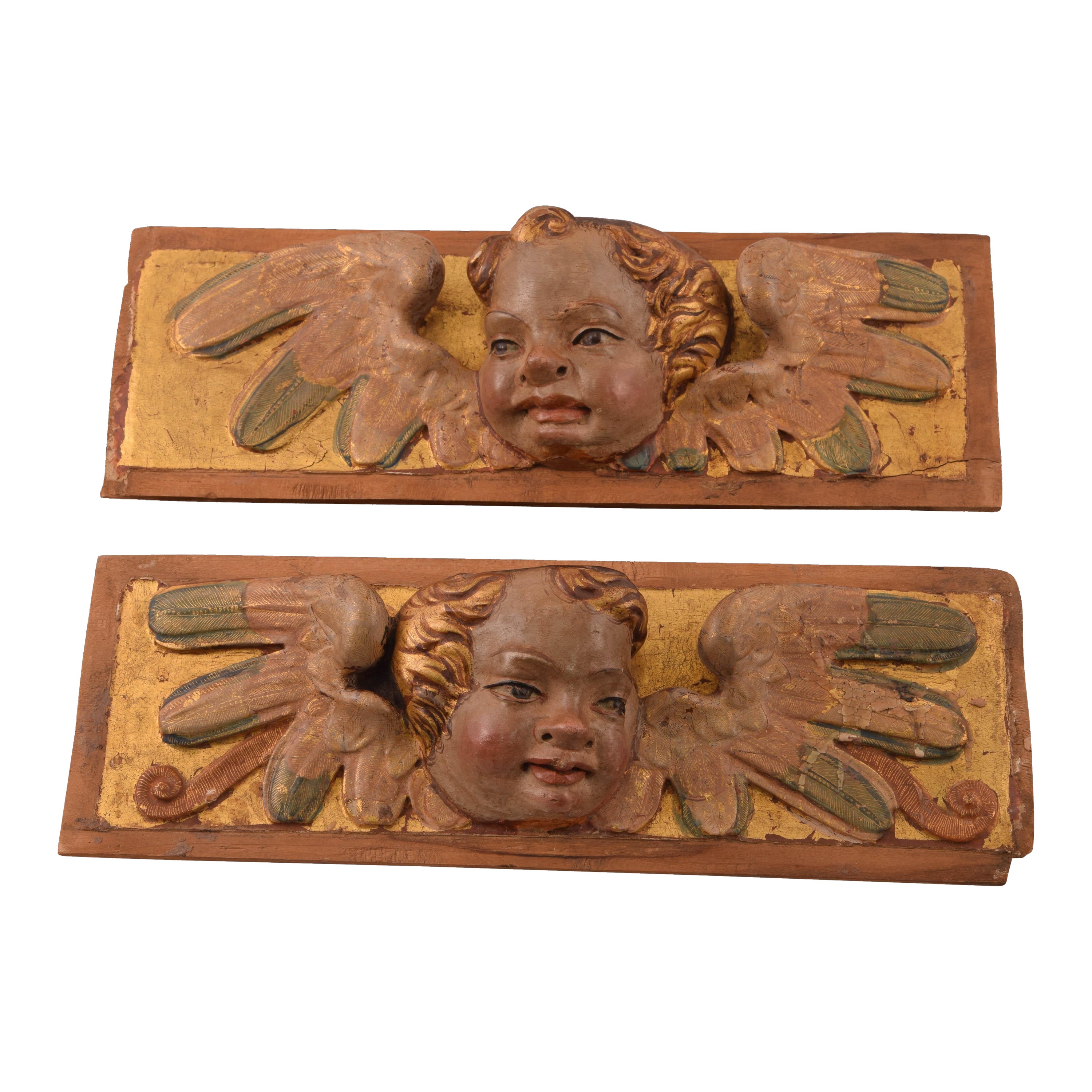 Reliefs with heads of angels. Polychrome and gilded wood. Spanish school, 16th c For Sale