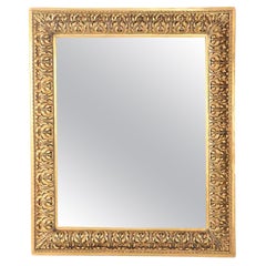 Antique A Nineteenth Century continental relief and gilt carved mirror.