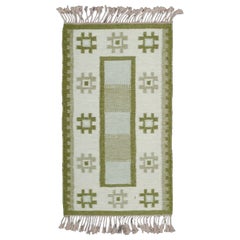 Vintage Sweden wool carpet in Rölakan technique. Green colors on a white background.