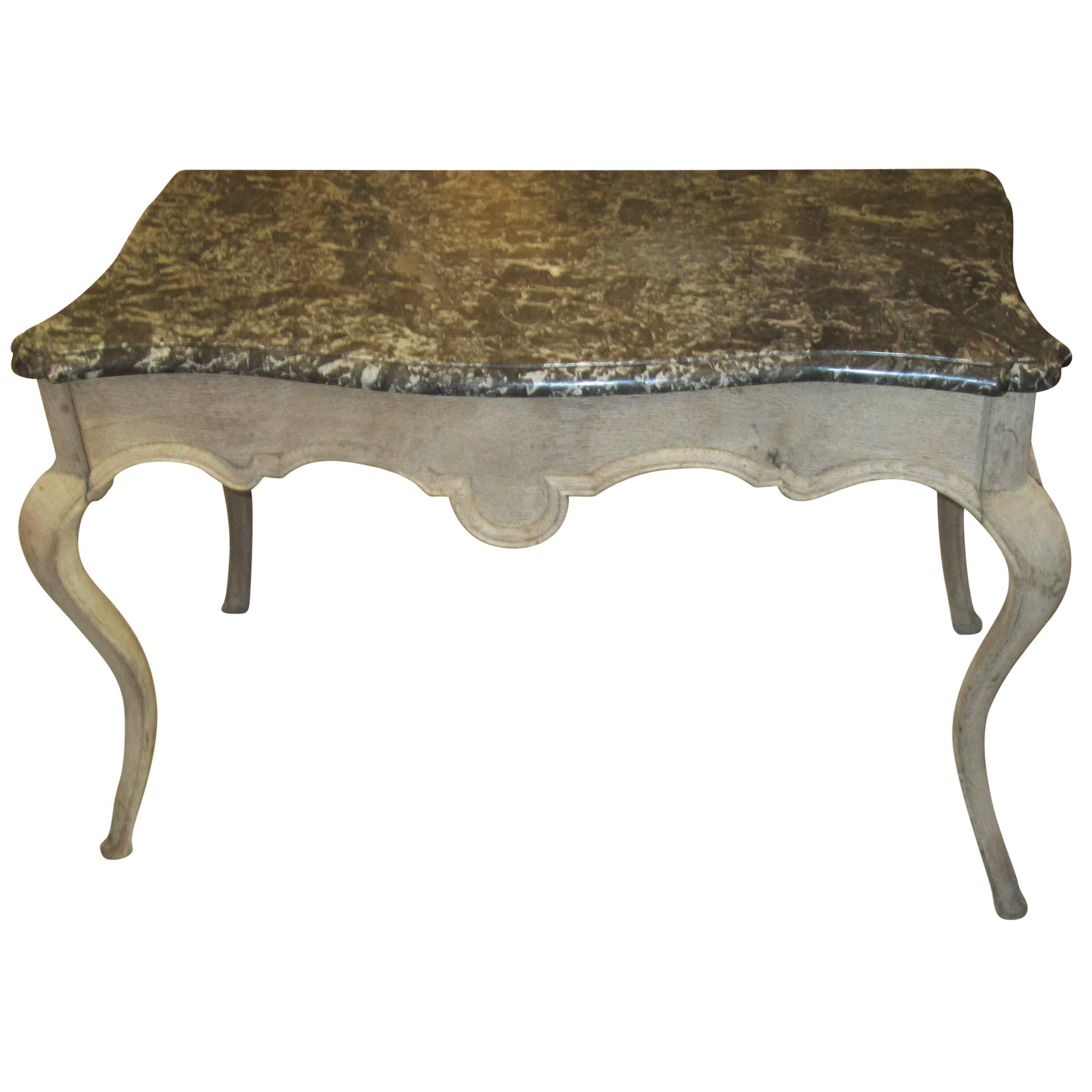 Whimsical Louis XV-style marble-top painted table on sabre legs.