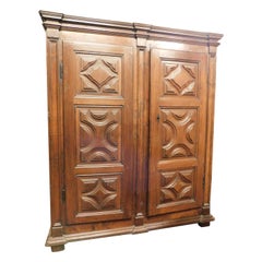 Two-door wardrobe armoires in carved walnut wood, Italy