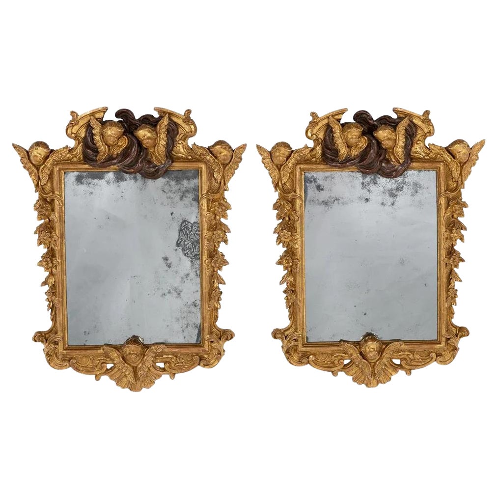 Paire de miroirs muraux baroques en bois doré et gesso en vente