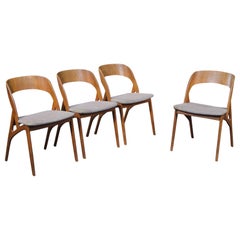 Set of four organic danish modern dining chairs in teak