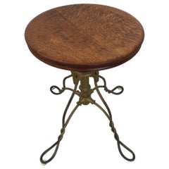 Retro Stool With Adjustable Wooden Seat and Wrought Iron Base.